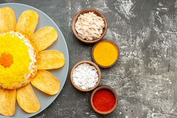 top view of salad on the left side with herbs centered on the dark grey background