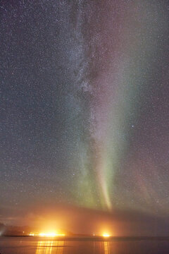 The Aurora Borealis (Northern Lights) seen over Olafsvik and Rif, on the right, Snaefellsnes peninsula, western Iceland