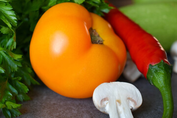Yellow tomato, hot pepper and champignon close up