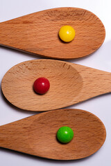 Wooden Spoons on White Background with colorful candy