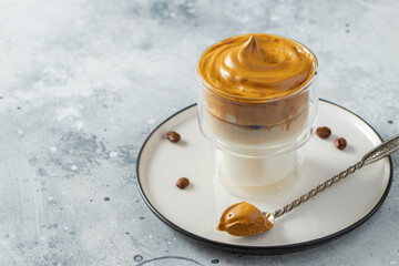 Dalgona coffee. Iced fluffy creamy whipped trend drink with coffee foam and milk. Trendy drink during Covid-19 city lock down and self quarantine, stay at home concept. With copy space