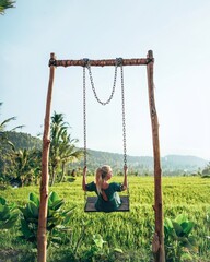 Woman on a swing over the ricefield in Bali, Indonesia
