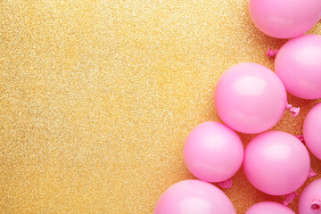 Pink balloons on gold background. Birthday, holiday concept.