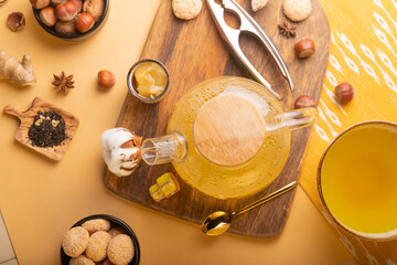 Fototapeta na wymiar Homemade ginger tea with honey in glass teapot 