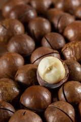 Heap of macadamia nuts as background. Food background. Close-up.