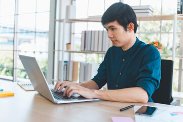businessman using laptop on desk in office