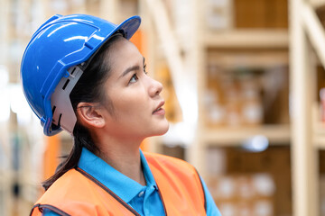Close up woman worker standing in the automotive parts warehouse store and look on the shelf....