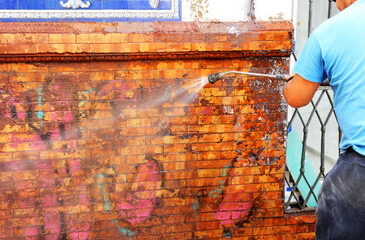 clean graffiti with high pressure water. Graffiti cleaning 