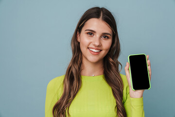 Fototapeta premium Happy beautiful cute girl smiling and showing mobile phone