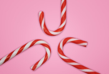 Red and White Candy Cane on Light Pink Background