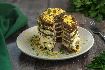 liver cake with golandy sauce and boiled egg on a wooden table