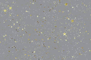 Gray background with shiny golden glitter on it. Dots, stars and little sparkles in flat lay stile....