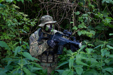 Croatia recon forces soldier camouflaging in the forest with the 
Cropat woodland uniform and...