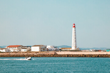 Beautiful lighthouse overlooking the ocean at sunset. Armona Island , Portugal