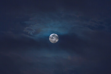 Naklejka na ściany i meble Full moon among the clouds in a blue night sky of Lima Peru