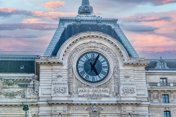 The clock of the Museum of Orsay in Paris at sunset