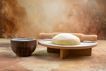 front view raw dough slice with flour on the cream desk pasta dish cuisine