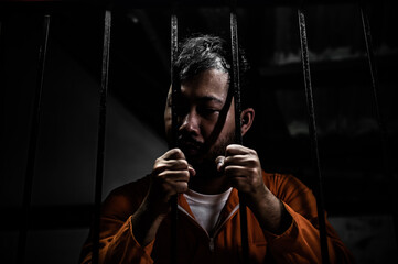 Asian man desperate at the iron prison,prisoner concept,thailand people,Hope to be free,Serious prisoners imprisoned in the prison