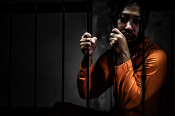 Asian man desperate at the iron prison,prisoner concept,thailand people,Hope to be free,Serious...