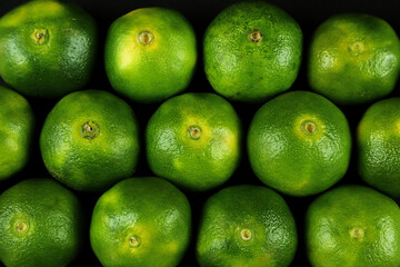 Green sweet tangerines growing with background