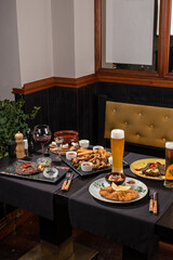 dining table food set with beer appetizer and drinks in restaurant