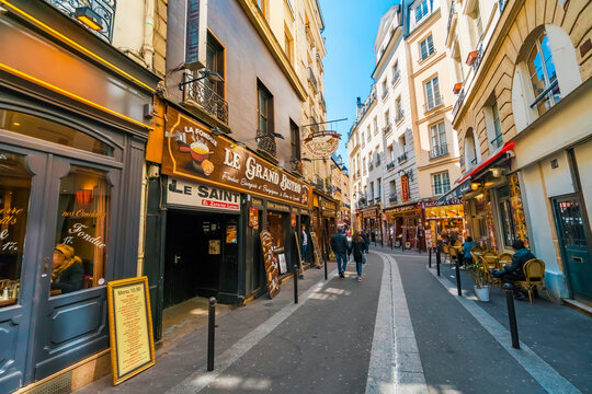 Paris, France - circa May, 2017: Latin Quarter. Narrow street of Paris among old traditional parisian houses and cafe