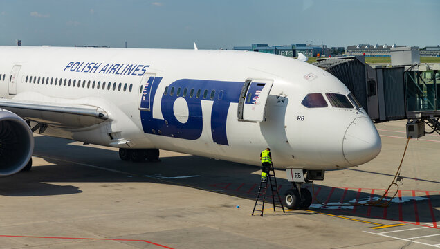 Warsaw, Poland - August 14, 2020: A picture of a LOT Airlines plane parked in the Warsaw Chopin Airport being maintained.