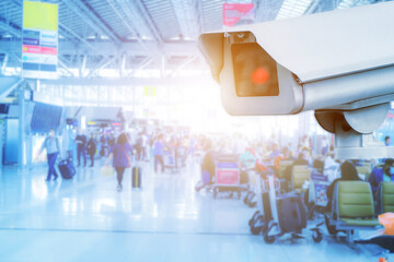 CCTV camera on a wall. A blurred night cityscape background. lungs separated. Airport check-in area.