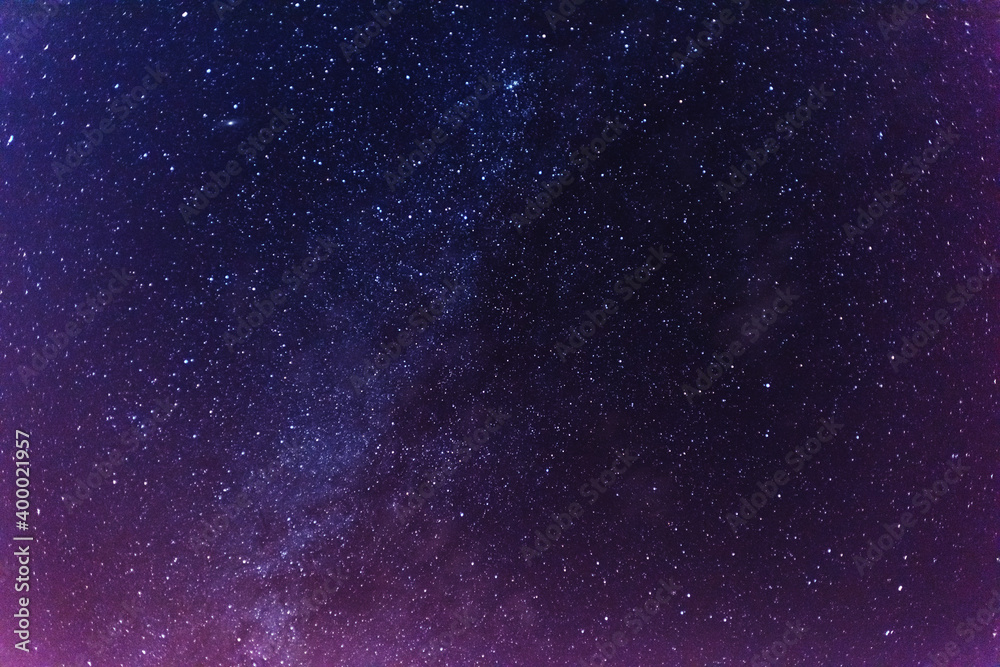 Wall mural a magical starry night on the river bank with a large tree and a milky way in the sky and falling st