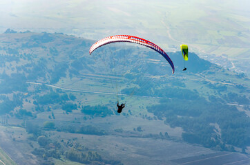 Two paragliders fly paraglider in the sky. Paragliding