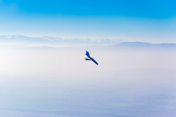 gliders and dramatic foggy sky, aerial pilot pov
