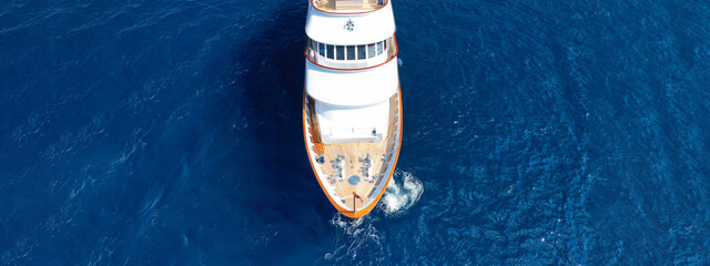 Aerial drone ultra wide photo of luxury yacht with wooden deck anchored in Mediterranean deep blue...