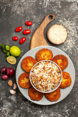 top view tasty fried cutlets with cooked rice on dark background meat rissole meal