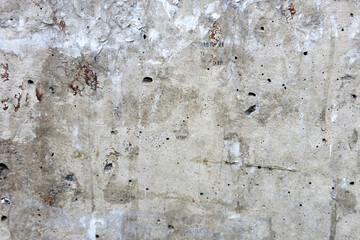 A cement wall with scraps of flyers on it  