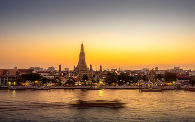 View of Wat Arun and Chao Phraya river at sunset. Buddhist Temple and Landmarks in Bangkok Thailand