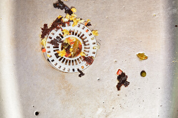 dirty sink with food leftovers. blockage sink with tap