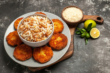 half-top view tasty fried cutlets with cooked rice on dark background meat rissole dish