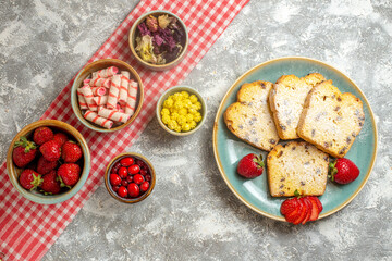 top view cake slices with fresh strawberries and candies on light background pie sweet fruit