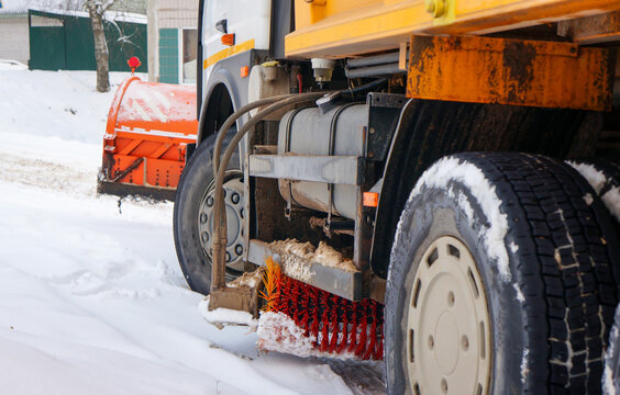 snow blower with bucket, brush and device for sprinkling roads close up, concept of cleaning roads from snow