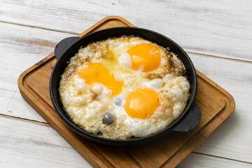 casually cooked scrambled eggs in a skillet