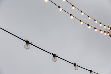 light bulb garlands against the grey sky