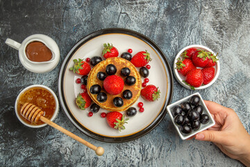 top view yummy pancakes with fresh fruits and honey on light background fruit cake sweet