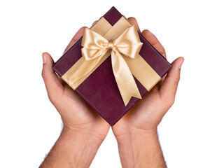 person holding a maroon gift box with golden ribbon on isolated white background
