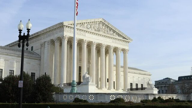 The exterior of the United States Supreme Court Building in Washington, D.C. as seen on a sunny day in late autumn. No people.