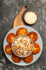 top view tasty fried cutlets with cooked rice on dark grey background meat rissole dish