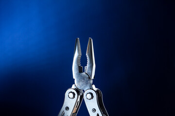 multitools steel on blue background. advertising poster.
