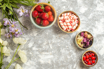 top view fresh red strawberries with candies on white background color berry fruit candy