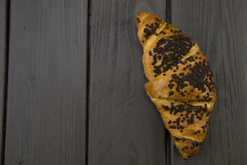 tasty croissants with chocolate on wooden background