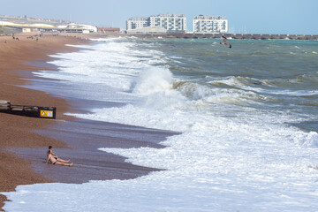 Naklejka premium sitting sunbathing by the sea in Brighton