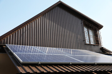 House with installed solar panels on roof. Alternative energy source